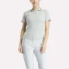Polo de golf ajustado con cremallera y manga corta para mujer Polo de golf ajustado con cremallera y manga corta para mujer