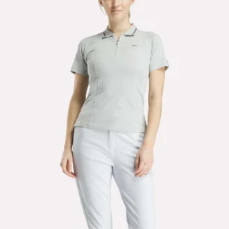 Polo de golf ajustado con cremallera y manga corta para mujer
