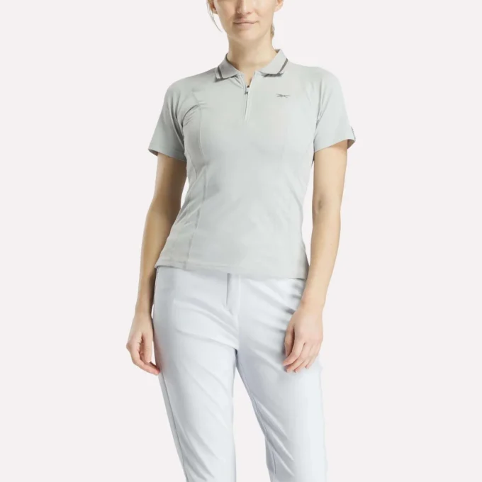 Polo de golf ajustado con cremallera y manga corta para mujer Polo de golf ajustado con cremallera y manga corta para mujer
