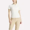 Polo de golf ajustado con cremallera y manga corta para mujer Polo de golf ajustado con cremallera y manga corta para mujer