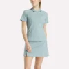 Polo de golf ajustado con cremallera y manga corta para mujer Polo de golf ajustado con cremallera y manga corta para mujer