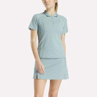 Polo de golf ajustado con cremallera y manga corta para mujer