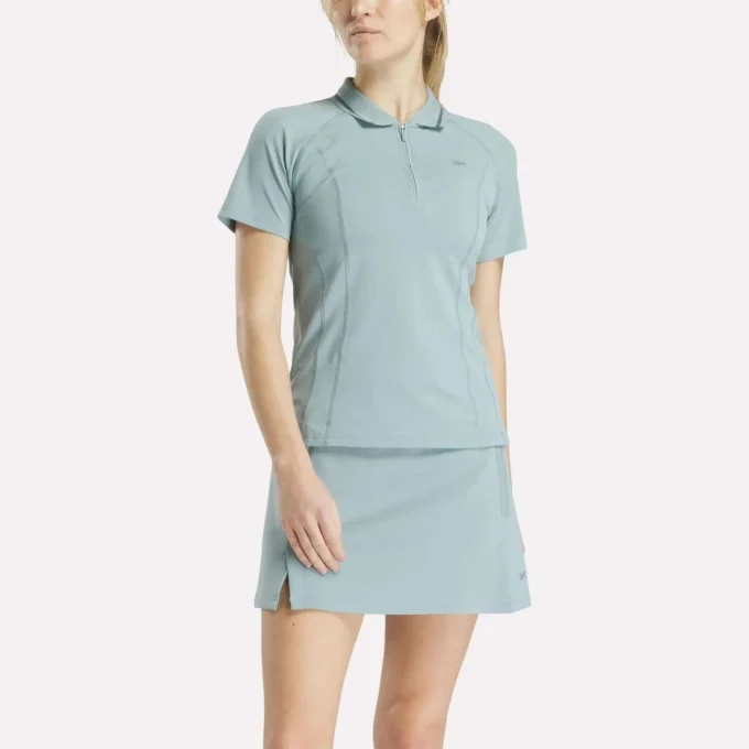 Polo de golf ajustado con cremallera y manga corta para mujer Polo de golf ajustado con cremallera y manga corta para mujer