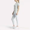 Polo de golf ajustado con cremallera y manga corta para mujer Polo de golf ajustado con cremallera y manga corta para mujer