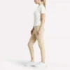 Polo de golf ajustado con cremallera y manga corta para mujer Polo de golf ajustado con cremallera y manga corta para mujer