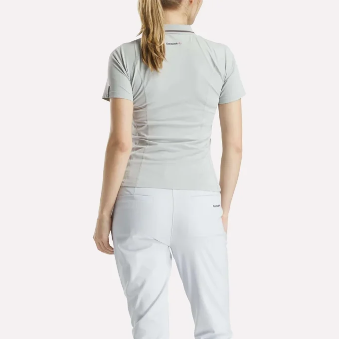 Polo de golf ajustado con cremallera y manga corta para mujer Polo de golf ajustado con cremallera y manga corta para mujer
