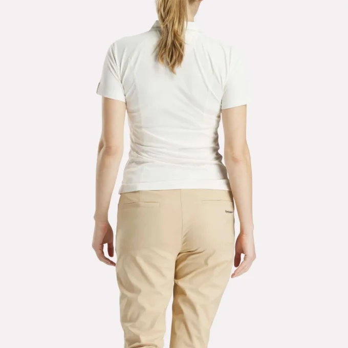 Polo de golf ajustado con cremallera y manga corta para mujer Polo de golf ajustado con cremallera y manga corta para mujer