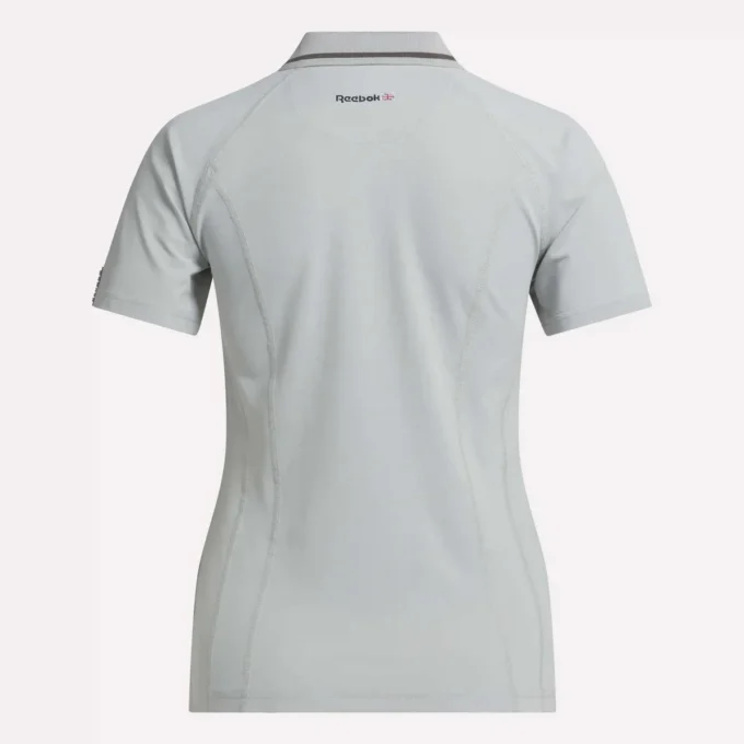 Polo de golf ajustado con cremallera y manga corta para mujer Polo de golf ajustado con cremallera y manga corta para mujer