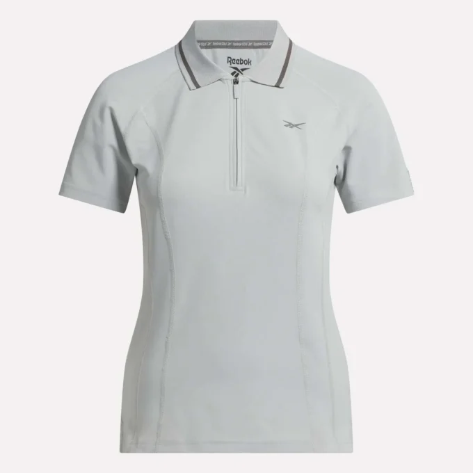 Polo de golf ajustado con cremallera y manga corta para mujer Polo de golf ajustado con cremallera y manga corta para mujer