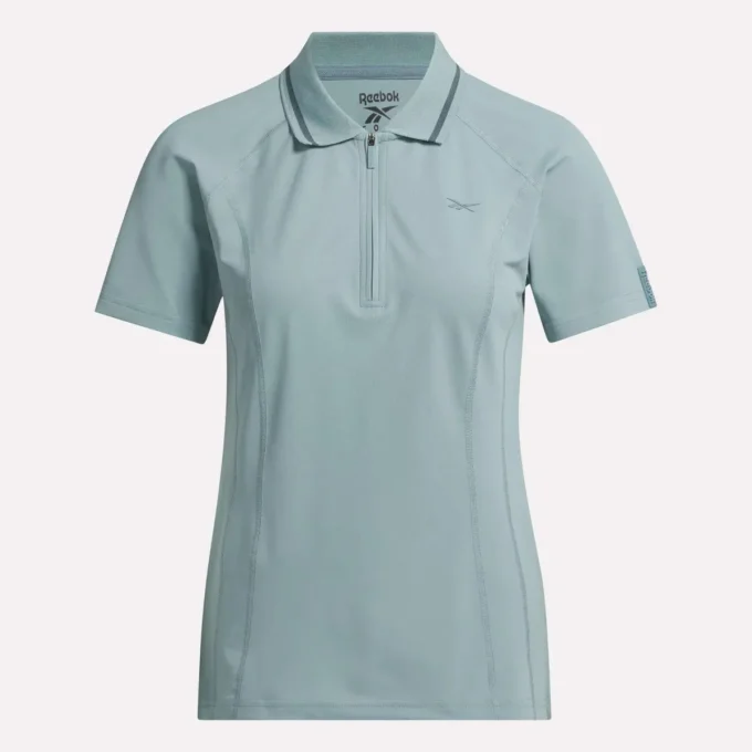 Polo de golf ajustado con cremallera y manga corta para mujer Polo de golf ajustado con cremallera y manga corta para mujer